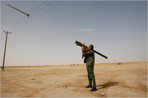 A rebel fires a rocket at a Libyan air force jet near on March 2 near Brega.