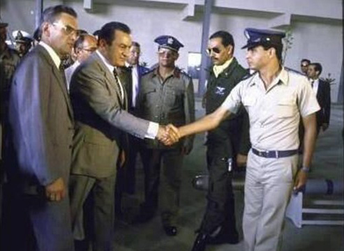 Husni Mubarak (left) shaking hands with Abdul Fattah Al-Sisi in an undated picture that Sisi's admirers see as the symbolic passing of a generational torch.