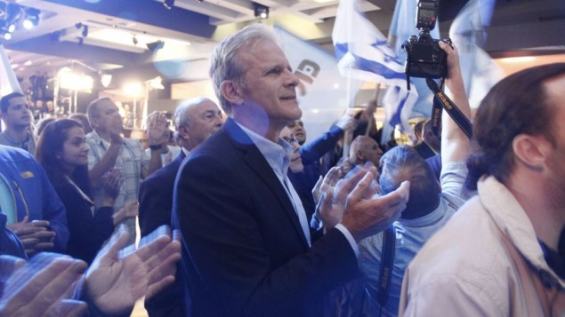 Michael Oren, number four on the Kulanu party's list, applauds as exit polls show his party is slated to receive between nine and ten seats in the 20th Knesset on March 17, 2015. It wound up with 10. (Photo credit: Judah Ari Gross/Times of Israel)