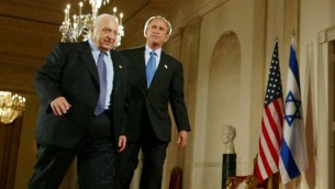 George W. Bush, right, and Ariel Sharon, left, walk together at the end of a joint press conference in the Cross Hall of the White House in Washington in April, 2004. (photo credit: AP/Pablo Martinez Monsivais, File)