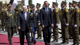 President Barack Obama, right, and Palestinian President Mahmoud Abbas, front left, walk along to red carpet for a troop review during an arrival ceremony as Obama arrives at the Muqata Presidential Compound Thursday, on March 21, 2013, in the West Bank town of Ramallah. (photo credit: AP Photo/Carolyn Kaster) 
