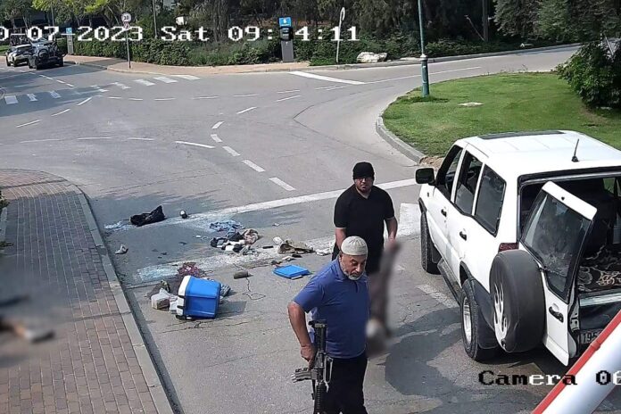 UNRWA social worker Faisal Ali Mussalem al-Naami (rear), carrying the body of a murdered Israeli man, is seen along with another terrorist at Kibbutz Be'eri, Oct. 7, 2023. Screenshot: South First Responders/Telegram.