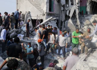 From Sderot to Tehran: Unmasking the architects of the ‘double war crime’ Iranians sift through the rubble of the Shajareh Tayyebeh girls’ school in Minab, Iran, destroyed by a missile strike on the first day of the joint U.S.-Israeli war on Feb. 28, 2026. Credit: Abbas Zakeri/Mehr News Agency/Creative Commons via Wikimedia Commons.